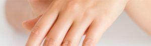 A woman's hand with a nail polish on it-Best Skin Treatment in Chennai