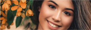 A close up of a woman in front of flowers- Laser Treatment Chennai